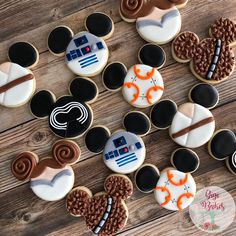 mickey mouse cookies decorated with royal icing and star wars decorations on top of a wooden table