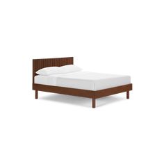 a bed with white sheets and brown headboard