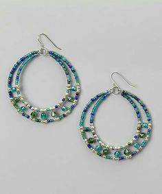 two hoop earrings with beads and glass beads on the bottom, one in blue and green