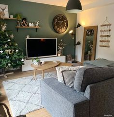 a living room filled with furniture and a flat screen tv mounted to the side of a wall