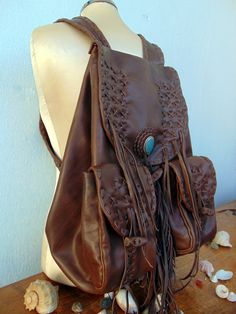 Backpack is Back Practical investment. The Big comeback of the Backpack!! continues sweeping for another season.!!. Comfortable Chic statement Bag. Handmade Brown Backpack. Genuine leather. Will become better with time and hard use. Also available in Black. Top oily Genuine leather with a sterling silver piece and turquoise stone on top of the cover!! Brown classic backpack - one design that we all know. To make this Bag, i have to use the hole skin of the calf.! because the main body of the bag Brown Backpack, Handmade Backpack, Native American Decor, Big Backpacks, Handmade Leather Backpack, Leather Fringe Bag, Handmade Backpacks, Comfortable Chic, Brown Backpacks