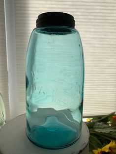 a blue mason jar sitting on top of a table