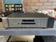 a silver and black stereo system sitting on top of a table