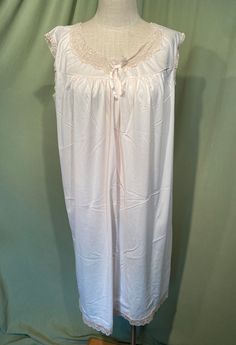 This lovely vintage nightgown is from the 1960s or early 70s. Labeled Philmaid. Tagged a size 40 /42. Bust measures 48", see measurements below.   Made of nylon in blush with beige trim. The gown slips over the head and sleeveless. Lace trims the arm openings, hemline. Applique lace trims the neckline. The gown reaches to the knee.  Condition is very good.  No wear or stains. Charming! Measure yourself & know your measurements before buying! Please remember that vintage sizes run small. It is best to measure yourself, or a gown that fits you well. Measurements were taken with the garment lying flat. Measurements were taken without stretching.  Bust measured 2" below the underarms: 24.5" for a 48" or smaller bust Waist from side seam to side seam: 27.5" for a 54" or smaller waist Hip from s Cream Sleeveless Sleepwear For Wedding Night, Vintage Sleeveless Nightgown For Bedtime, Cream Sleeveless Nightgown With Lace Trim, Vintage Cream Sleeveless Sleepwear, Cream Sleeveless Sleepwear With Lace Trim, Sleeveless Cream Nightgown For Bedtime, Cream Sleeveless Nightgown For Bedtime, Vintage Sleeveless Nightgown For Loungewear, Vintage Sleeveless Cream Nightgown