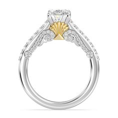 a diamond engagement ring with two tone gold accents