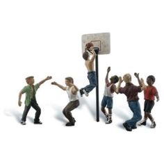 small figurines of men playing basketball in front of a hoop