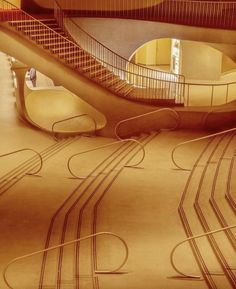 the interior of a modern building with curved staircases