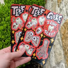 two stickers that say goree and have teeth on them in front of some bushes