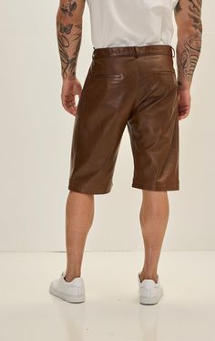 Elevate your wardrobe with the ultimate statement in luxury and style: Men's Genuine Lambskin Leather Shorts. Crafted from the finest lambskin leather, these shorts offer an unmatched softness and a supple texture that gracefully conforms to your body, providing not just comfort but a flattering fit that enhances your silhouette. The natural breathability of lambskin ensures these shorts remain comfortable even on warmer days, blending functionality with finesse. Perfect for a range of occasions, from casual gatherings to more elevated events, these shorts can be dressed down with a simple tee and sneakers or dressed up with a button-down shirt and loafers. COMPOSITION Made in Turkey 100% Leather Style #2758 CARESpecialist Leather Clean Only Fitted Leather Shorts, Fitted Short Leather Pants, Short Leather Bottoms With Belt Loops, Fitted Short Leather Bottoms, Luxury Brown Leather Bottoms, Leather Brown Shorts, Chic Brown Faux Leather Shorts, Brown Leather Short Bottoms, Brown Faux Leather Shorts