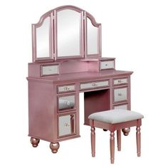 a pink vanity with mirror and stool