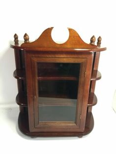 an old wooden shelf with a mirror in it