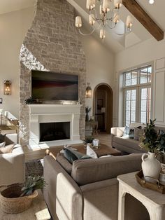 a living room filled with furniture and a fire place in the middle of a room