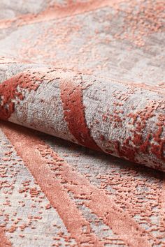 an orange and grey rug with red lines on it's edges, laying on the floor