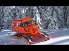 an orange truck is driving through the snow