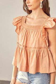 Final Sale - Get it before it's gone! Beautiful weather calls for the Dani Apricot Ruffle Babydoll Top! This flowy, woven top has a square neckline, short ruffle sleeves, and a wide-cut bodice. A relaxed silhouette features a ruffled trim drop seam tier with a ruffle hem. Tassel tie back finishes the look. Pair with your favorite shorts for a cute warm-weather look! DETAILS & CARE Cotton. Machine wash cold. Imported. Summer Smocked Top With Ruffle Hem And Short Sleeves, Spring Smocked Top With Square Neck, Summer Smocked Puff Sleeve Top, Summer Solid Color Smocked Puff Sleeve Top, Solid Summer Smocked Top With Puff Sleeves, Chic Summer Smocked Top With Ruffle Sleeves, Flowy Smocked Top With Square Neck For Spring, Chic Ruffle Sleeve Smocked Top For Summer, Solid Puff Sleeve Smocked Top For Summer