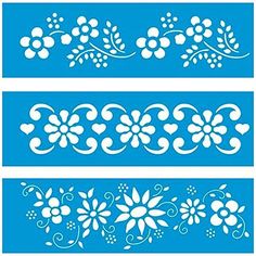 three different stencils with white flowers and hearts on blue paper, one is cut out