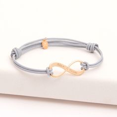 Love and friendship can last a lifetime with our Personalized Infinity Bracelet. Create a meaningful personalized gift with your hand-engraved message on the charm.18K Champagne Gold Plated, 925 Sterling Silver or 18K Rose Gold PlatedInfinity charm: 1” x 0.4”Braid made of durable, colorfast polyesterFully adjustable sliding knot fasteningThis product is also available for menEngraved by hand in our Paris workshopSent with love in a complimentary gift boxAny slight variations in lettering depth, Infinity Charm Bracelet, Adjustable Sliding Knot, 4 Braids, Colored Braids, Infinity Charm, Love And Friendship, Engraved Bracelet, Sliding Knot, Champagne Gold