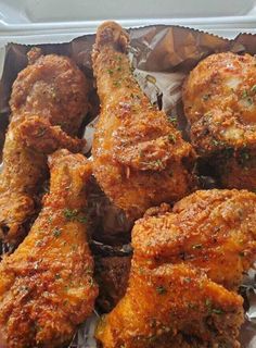 chicken wings with parsley on top in a takeout container