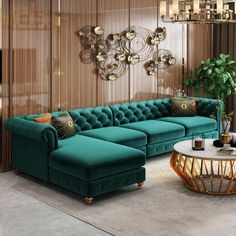 a living room filled with green couches next to a table and chandelier