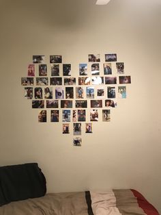 a heart shaped photo hanging on the wall above a bed