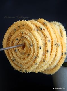 a close up of a pastry with chocolate chips on it and a spoon in the middle