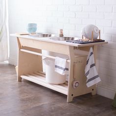 a wooden sink with two bowls on it