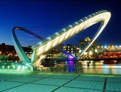 an illuminated bridge over a body of water at night