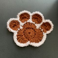 an orange and white crocheted dog paw