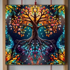 a colorful tree is hanging on the wall