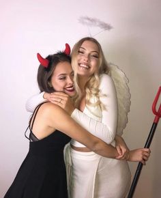 two women dressed in devil costumes hugging each other