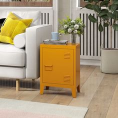 a yellow locker next to a white couch in a living room