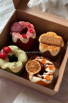 an open box filled with different types of donuts