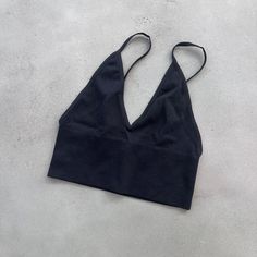 Aritzia Toni Seamless Tank, Size S, Black. This Is A Seamless V-Neck Bra Top With Adjustable Straps And A Low Open Back. It's Made From Stretchy Ribbed Fabric Specially Knit For A Barely-There Feel. Never Worn, No Tags, Pristine Condition. Black V-neck Crop Top With Built-in Bra, Black Triangle Top Sports Bra With Built-in Bra, Fitted Black V-neck Sports Bra, Seamless V-neck Crop Top For Party, Black Seamless V-neck Sports Bra, Black Stretch Crop Top With Built-in Bra, Low-cut Tops With Built-in Bra For Loungewear, Low-cut Fitted Sports Bra For Loungewear, Black Seamless Tank Top For Yoga