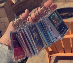 a person holding up several different cd's in their hand