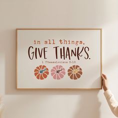 a person holding up a sign that says in all things give thanks