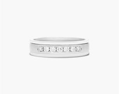 a white gold wedding band with five diamonds