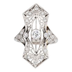 Finely detailed antique Edwardian ring (circa 1900s to 1910s) crafted in 900 platinum.   Centrally mounted estimated 0.25 carat old Mine cut diamond is accented with 18 x estimated 0.02 to 0.03 carat diamonds. The total diamond weight is estimated at 0.63 carats. The diamonds are estimated at H-I colour and SI1-2 clarity.   The ring features lacy filigree detail within an elongated shield mount, a hallmark of the Edwardian era. With a slight curved saddle the ring sits comfortably on the finger Edwardian Diamond Ring, Diamond Ring Platinum, Edwardian Ring, Antique Jewelry Rings, Old Mine Cut Diamond, Vintage Fine Jewelry, Diamond Cluster Ring, Diamond Cluster, Antique Rings