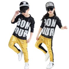 two children wearing gold pants and black shirts with the words bonn pour on them