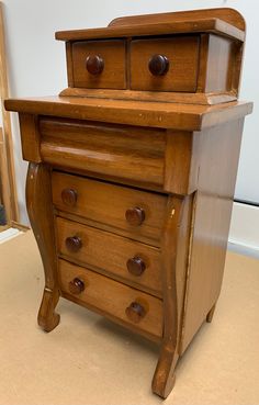 an old wooden dresser with three drawers