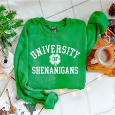 Our t-shirts, crewneck sweatshirts and hoodies are a "UNISEX" style. Women should buy their normal size, or a smaller size for a more fitted look. University of shenanigans.  INFO  - Gildan 18000 - 50% Cotton 50% Polyester - Medium-heavy fabric (8.0 oz/y² (271.25 g/m - Loose fit - Sewn-in label - Runs true to size - Without side seams - Depending on what device you are viewing listing color may vary slightly. - Mockups might not be 100% accurate  SIZES - Please see picture for sizing information Kids Candles, Candle Bags, St. Patrick’s Day, Lucky Shamrock, Information Processing, St Paddy, St Pattys, Oversized Pullover, Saint Patrick