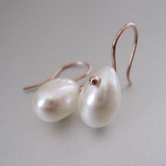 Large, creamy freshwater pearls have been drilled at the top and hung from 14k rose gold ear wires. The 12mm natural pearls glow with just the slightest blush which pairs nicely with the polished rose gold. The earrings hang 7/8" total and can be made in white (see modeled pic) and yellow gold as well. *These earrings are made to order and will be made with nearly identical pearls. Rose Gold Pearl Charm Earrings For Anniversary, Formal Rose Gold Pear-shaped Pearl Earrings, Classic Rose Gold Pearl Drop Earrings, Rose Gold Teardrop Pearl Earrings For Anniversary, Minimalist Rose Gold Pearl Earrings For Anniversary, Rose Gold Drop Pearl Earrings Gift, Rose Gold Teardrop Pearl Earrings As Gift, Rose Gold Teardrop Pearl Earrings With Ear Wire, Rose Gold Teardrop Pearl Earrings For Formal Occasions