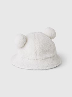 Soft sherpa bucket hat.  Flutter brim.  Pom bear ears at top.  This bucket hat is made with 50% recycled polyester.  Compared to virgin materials, using recycled materials helps to reduce resource use and waste.  This product was made in a factory that runs the Gap Inc.  P. A. C. E.  Personal Advancement & Career Enhancement) program.  P. A. C. E.  is our educational program that helps the women who make our clothes build the skills, knowledge, confidence & resilience needed to advance in work & Bear Bucket Hat, Sherpa Bucket Hat, Bear Ears, Baby Gap, The Gap, Recycled Materials, Baby Toddler, Bucket Hat, Gap