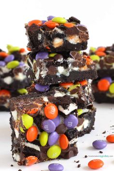 halloween brownies are stacked on top of each other with candy and marshmallows