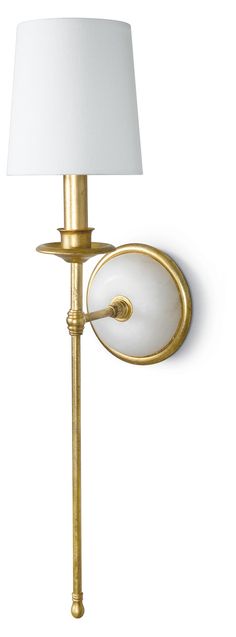 a wall light with a white shade on the side and a gold metal pole attached to it