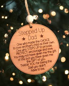 a wooden ornament hanging on a christmas tree reads, stepped up dad one who made the chair