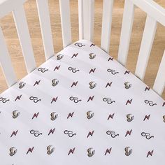 a white crib with glasses and anchors on it