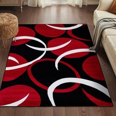 a red and black area rug with white circles on it in a living room setting