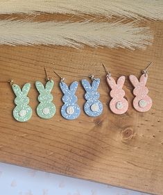 four different colored wooden bunny earring designs