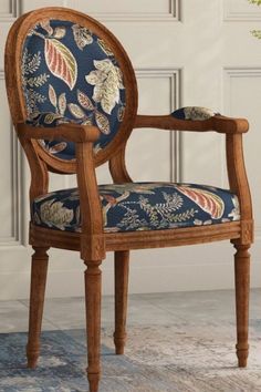 a wooden chair with blue floral upholstered seat