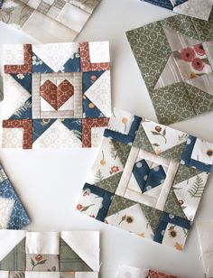 several quilt blocks are laid out on the table